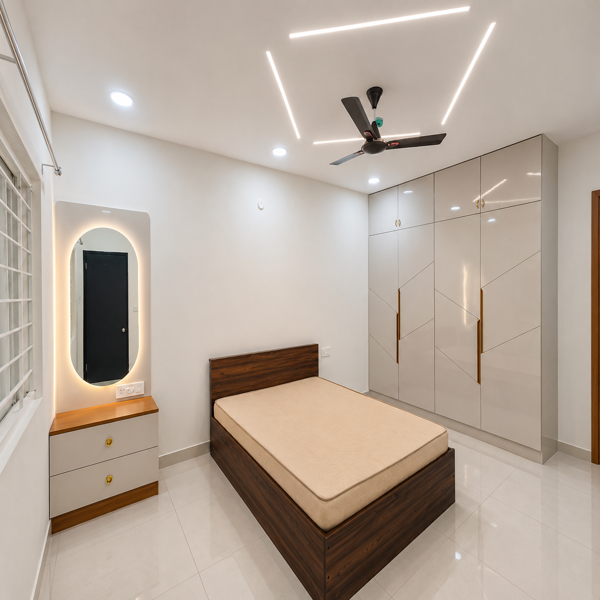 Modern bedroom, luxury bedroom, contemporary bedroom, stylish bedroom, spacious bedroom, apartment bedroom, master bedroom, residential interior, modern home, elegant interior, wooden bed, double bed, queen size bed, wooden headboard, upholstered mattress, built-in wardrobe, wardrobe cabinets, white wardrobe, glossy wardrobe, storage cabinets, bedside table, nightstand, dressing table, illuminated mirror, LED mirror, wall mirror, modern furniture, wooden accents, white walls, glossy floor tiles, tiled flooring, ceiling fan, LED ceiling lights, false ceiling, recessed lighting, bright room, natural light, large window, window grill, minimalist design, clean bedroom, neat interior, premium apartment, luxury apartment, modern architecture, contemporary decor, home interior, residential property, spacious living, elegant home, urban apartment, interior design.